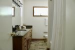 Main floor bathroom with tub/shower and tons of counter space
